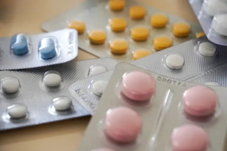 When the Cure Becomes the Threat: - Close-up view of assorted colorful medication blister packs with diverse pills.